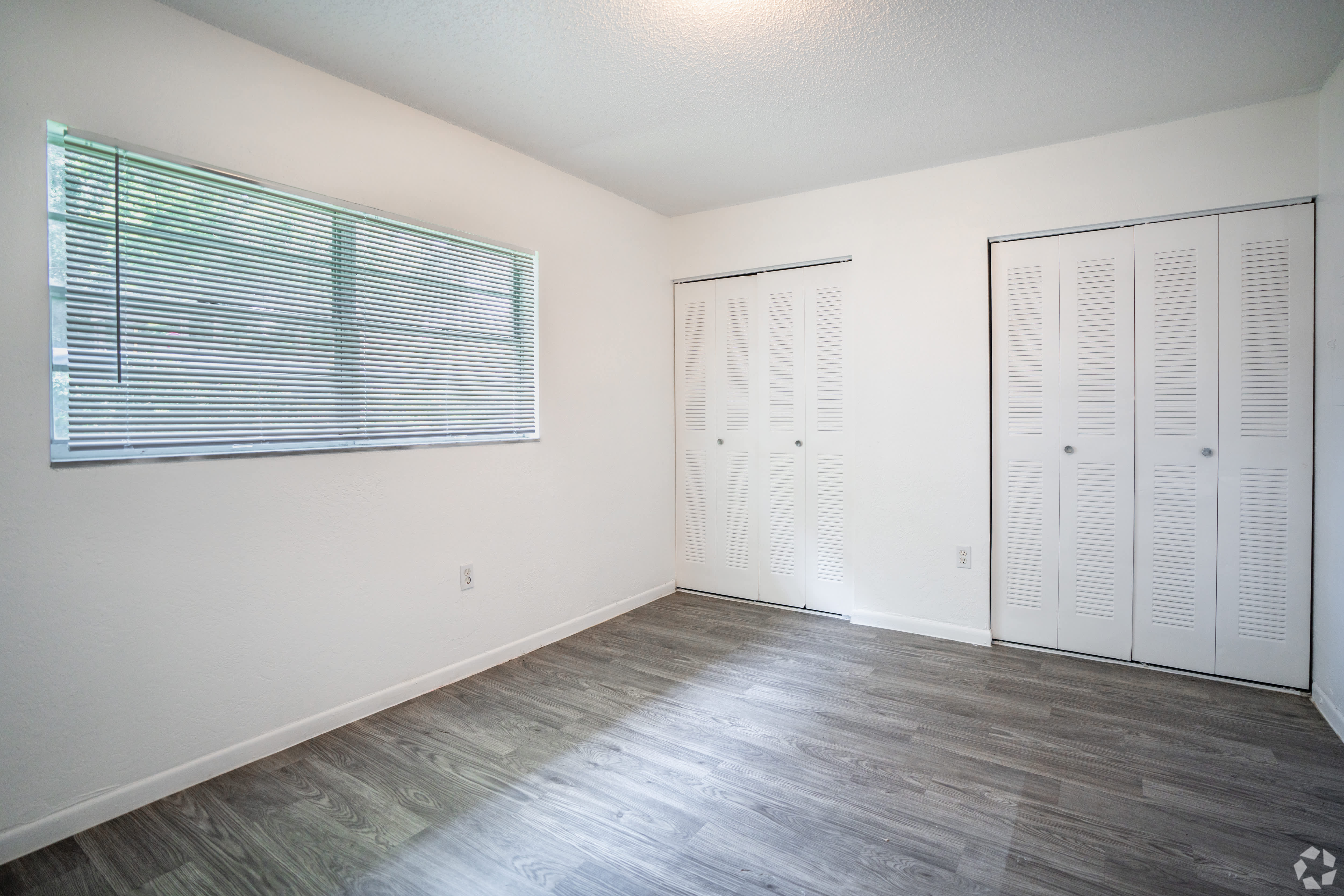 Bedroom with two louvered closet doors