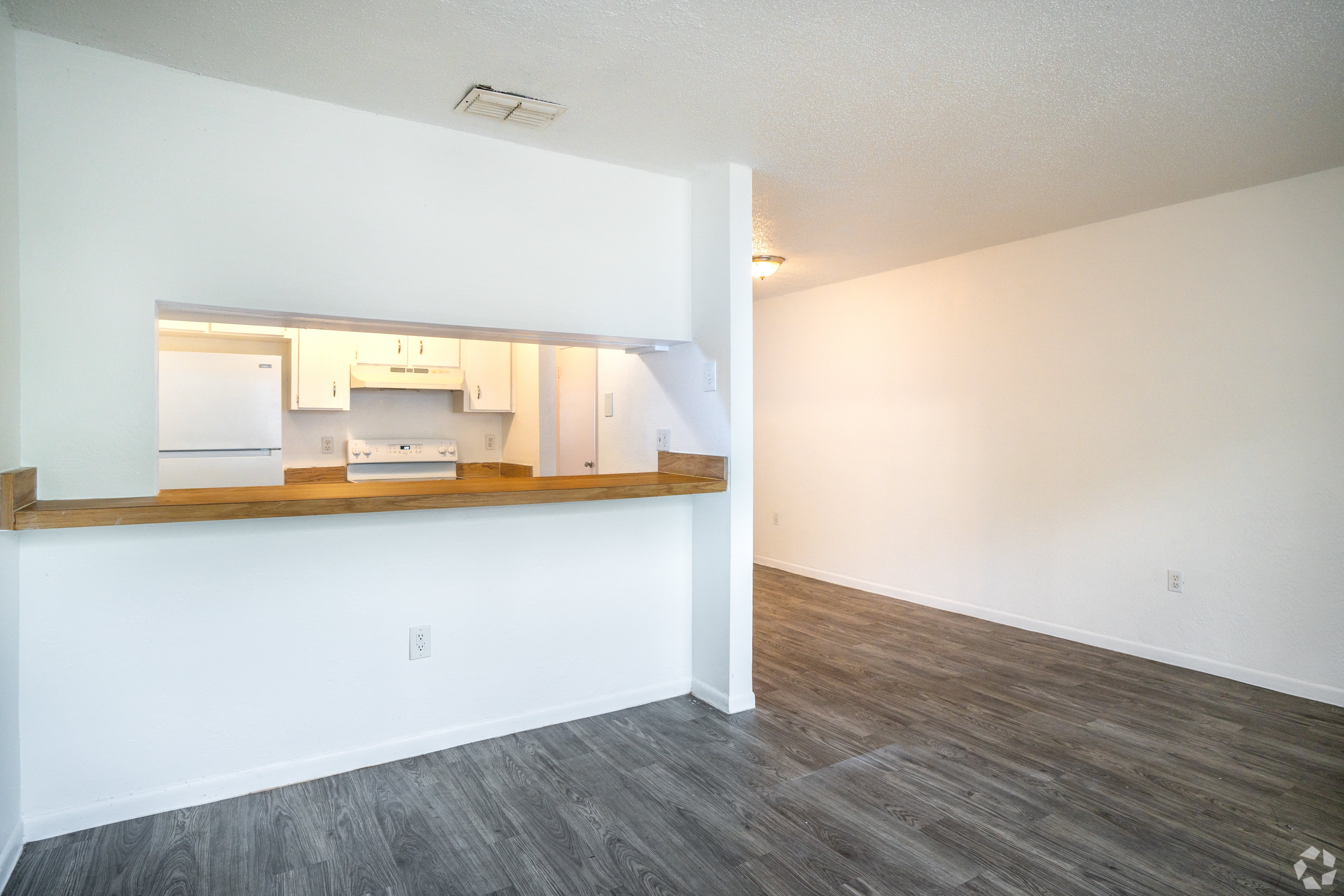 Open living and dining with a kitchen pass-through bar